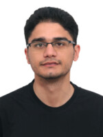 A man in a black t-shirt and spectacles