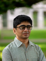 Photo of Kunal Mehta, a man with glasses wearing a collared shirt